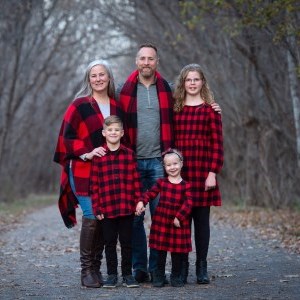 Dawson family wearing matching plaid and surrounded by trees