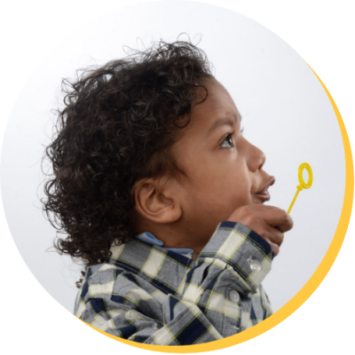 Young boy blowing bubbles