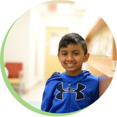 Young boy standing in a clinic hallway