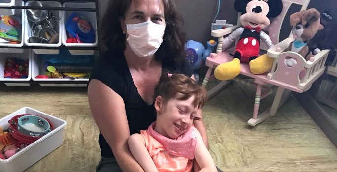 Parent and their child sitting, surrounded by toys