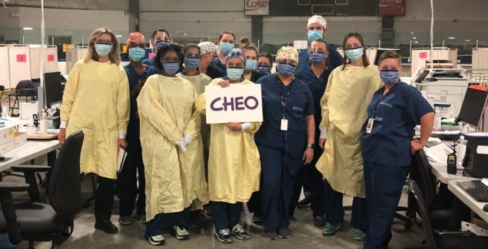 Brewer testing team in PPE holding a "CHEO" sign