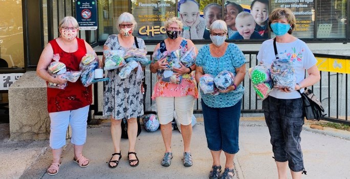 Community members at CHEO's main entrance dropping off hand sewn masks