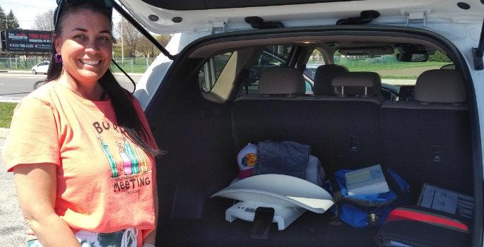 Photo of CHEO Home and Community Care nurse Melissa, standing in front of her van on her way to appointments