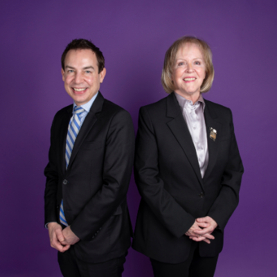 Alex Munter and Jo-Anne Poirier standing in front of a purple background