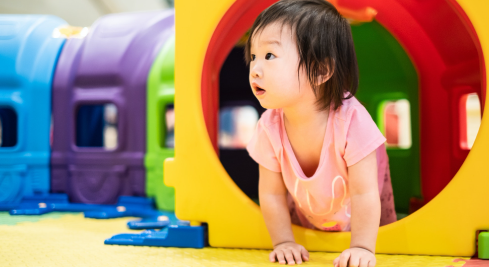 Toddler crawling outside a tunnel