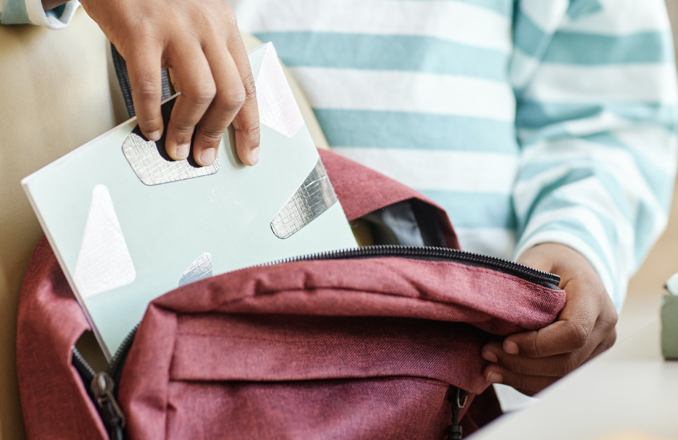 Placing book in backpack