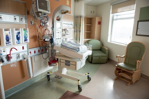 A NICU room with an overbed