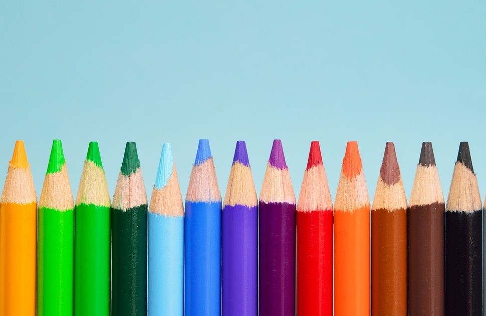 Pencil crayons lined up in a variety of colours