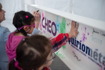 kids paint metal beam with painted hands