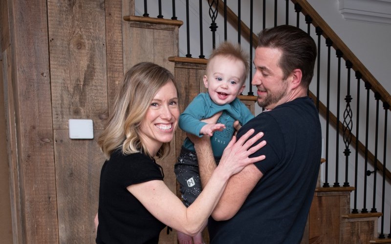 Family photo of Aiden and his family, smiling at the camera