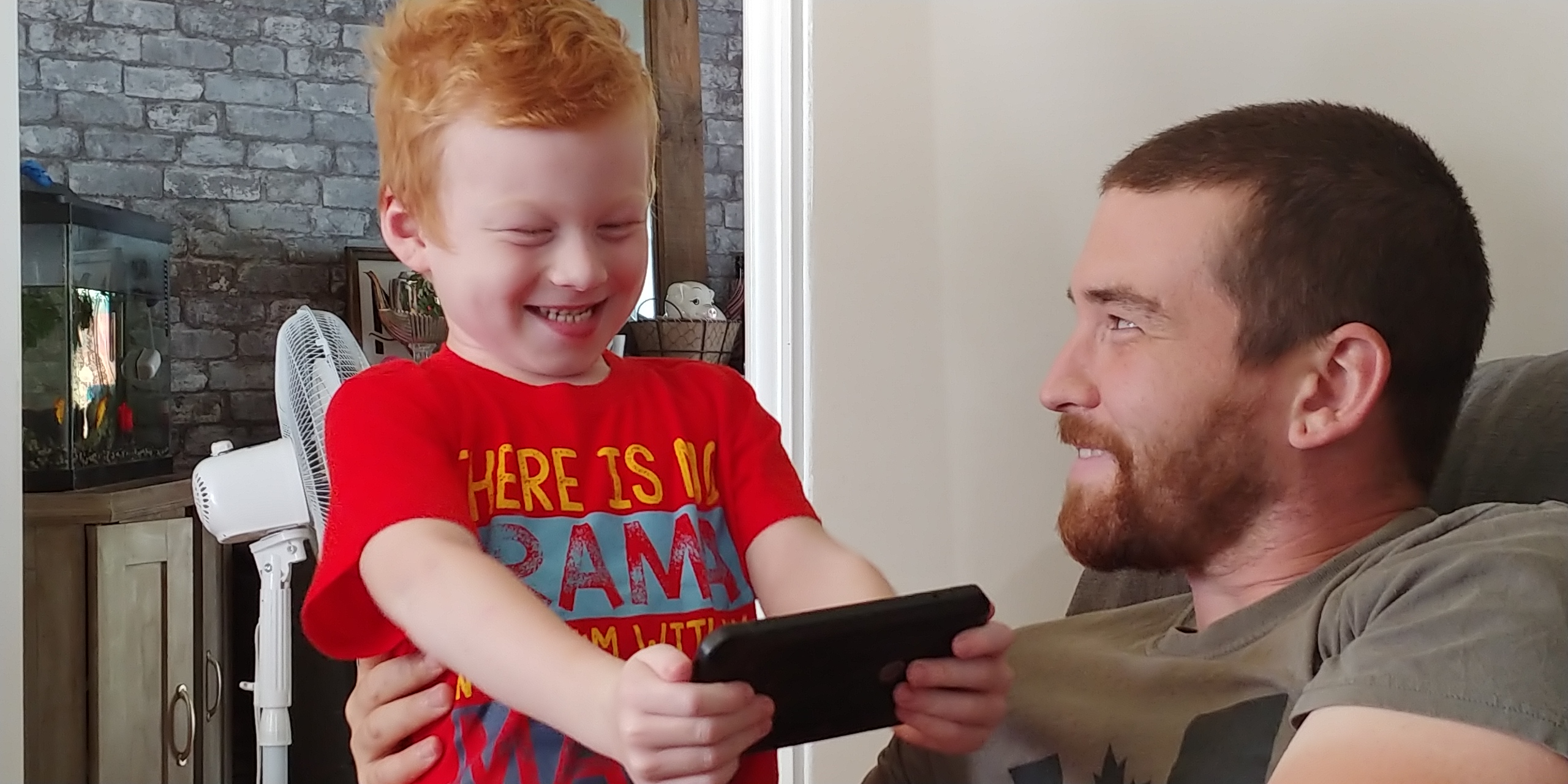 Declan and his father smiling at each other