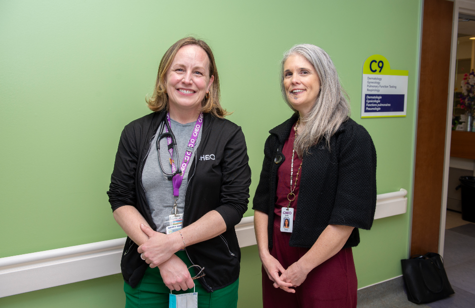 nurse and pediatrician smile in front of respirology clinic at cheo