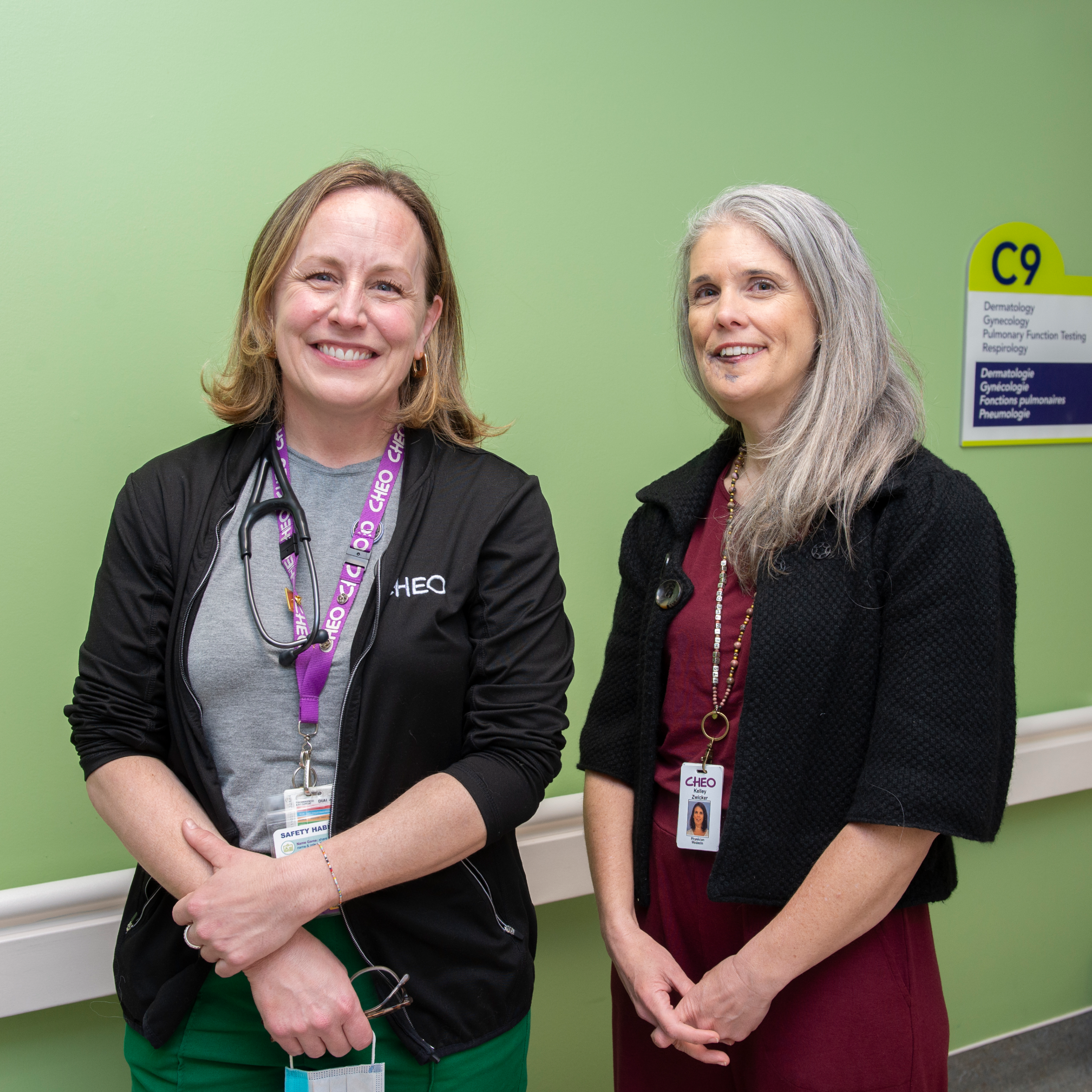nurse and pediatrician smile in front of respirology clinic at cheo