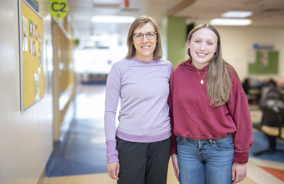 A woman and daughter pose in a hallway at CHEO