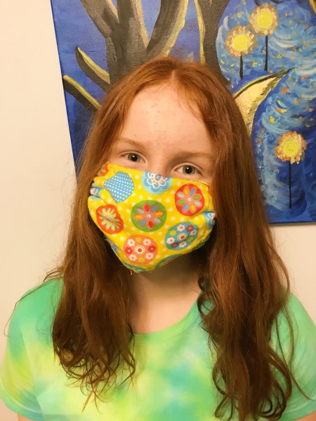 Young girl wearing a colourful cloth mask