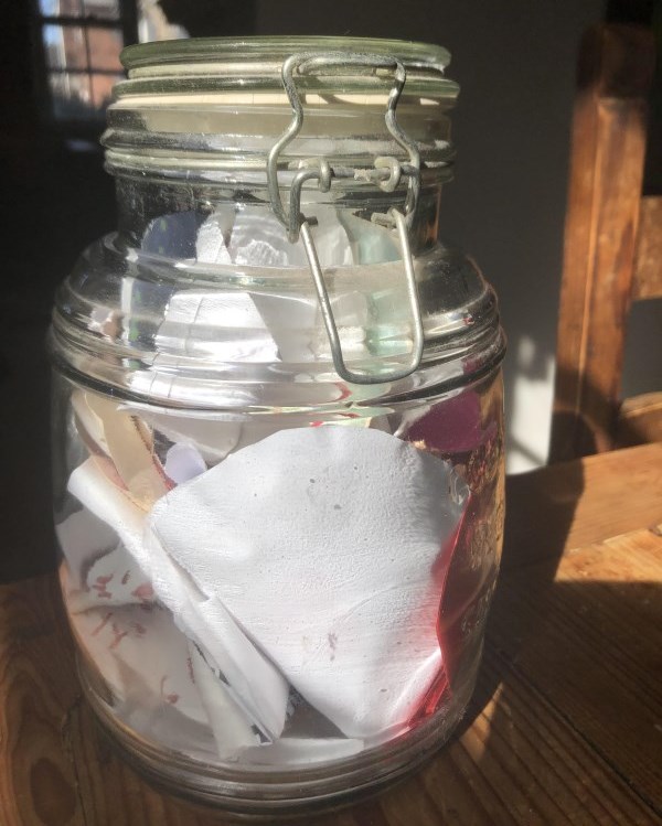 Glass jar with paper hearts
