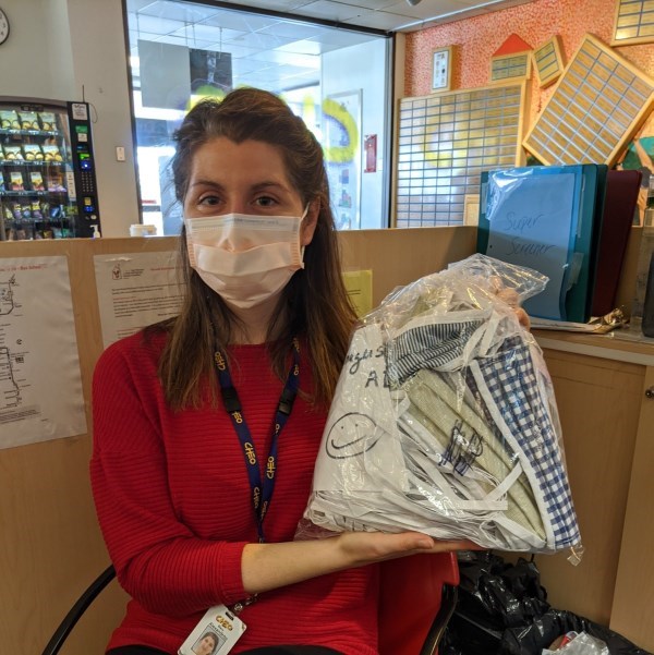 Sophie Contant holding a bag of donated cloth masks