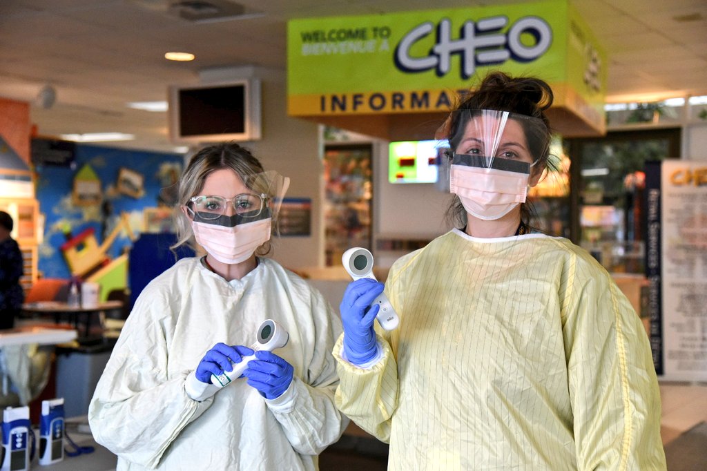 CHEO staff in masks and gowns, ready to screen those entering the building!