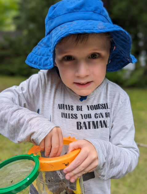 Cameron. He wears a blue hat and holds a bucket.