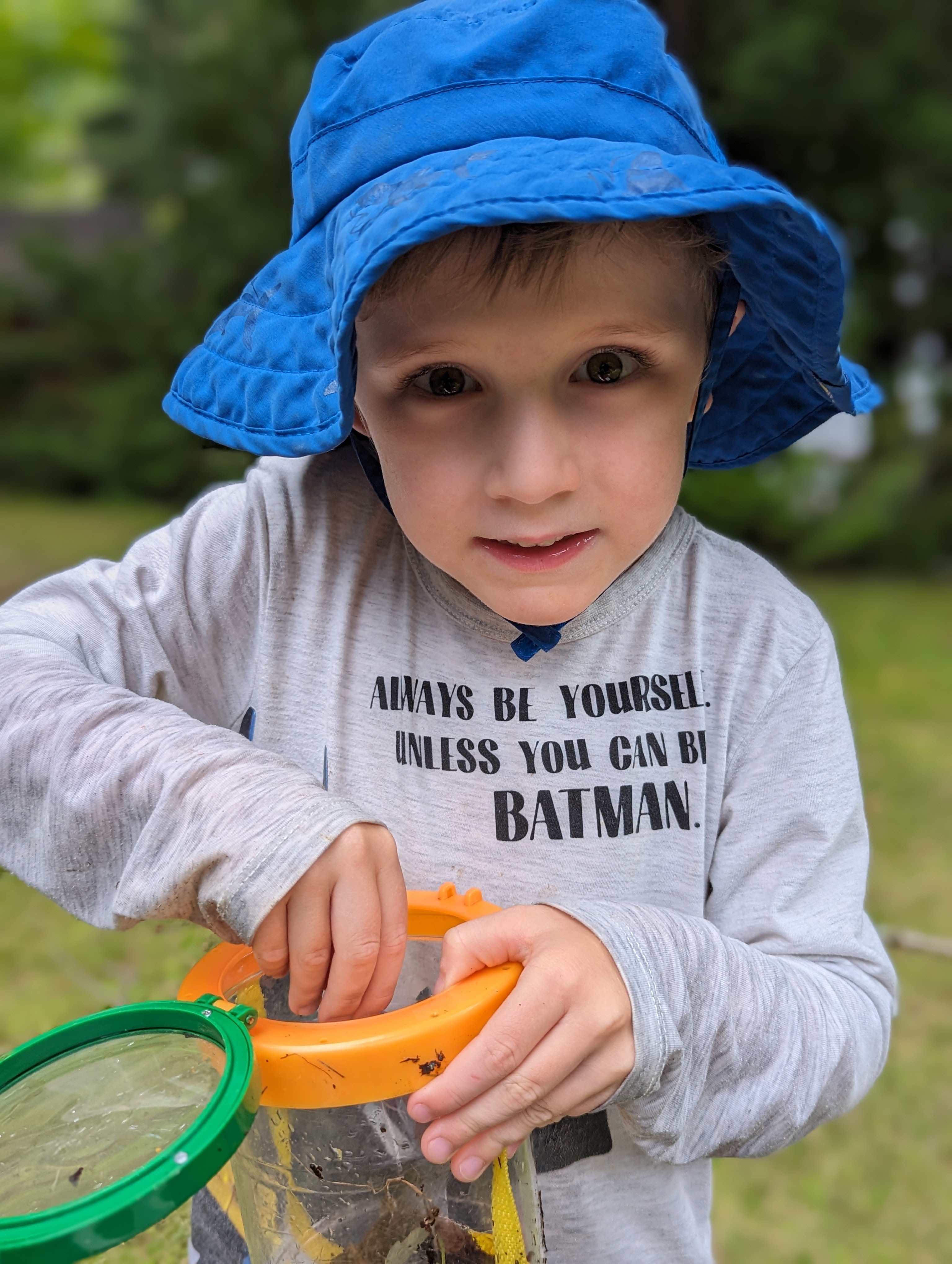 Cameron. He wears a blue hat and is holding a bucket.