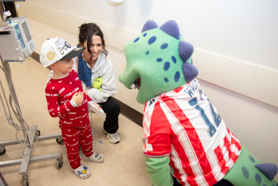 dinosaur mascot with child
