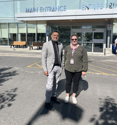 doctor and clinical manager from cheo stand in front of hospital
