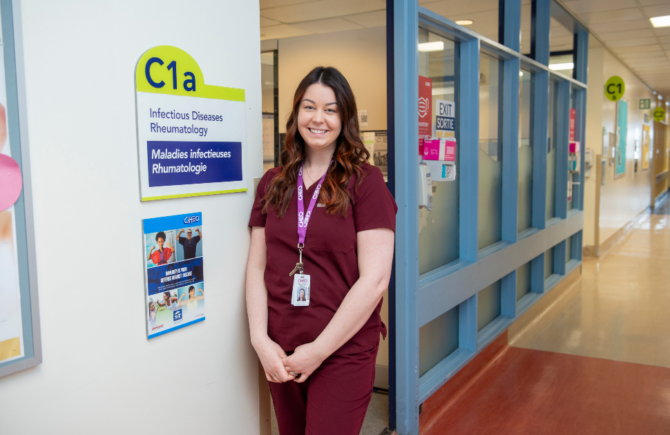 nurse poses for photo outside immunology clinic