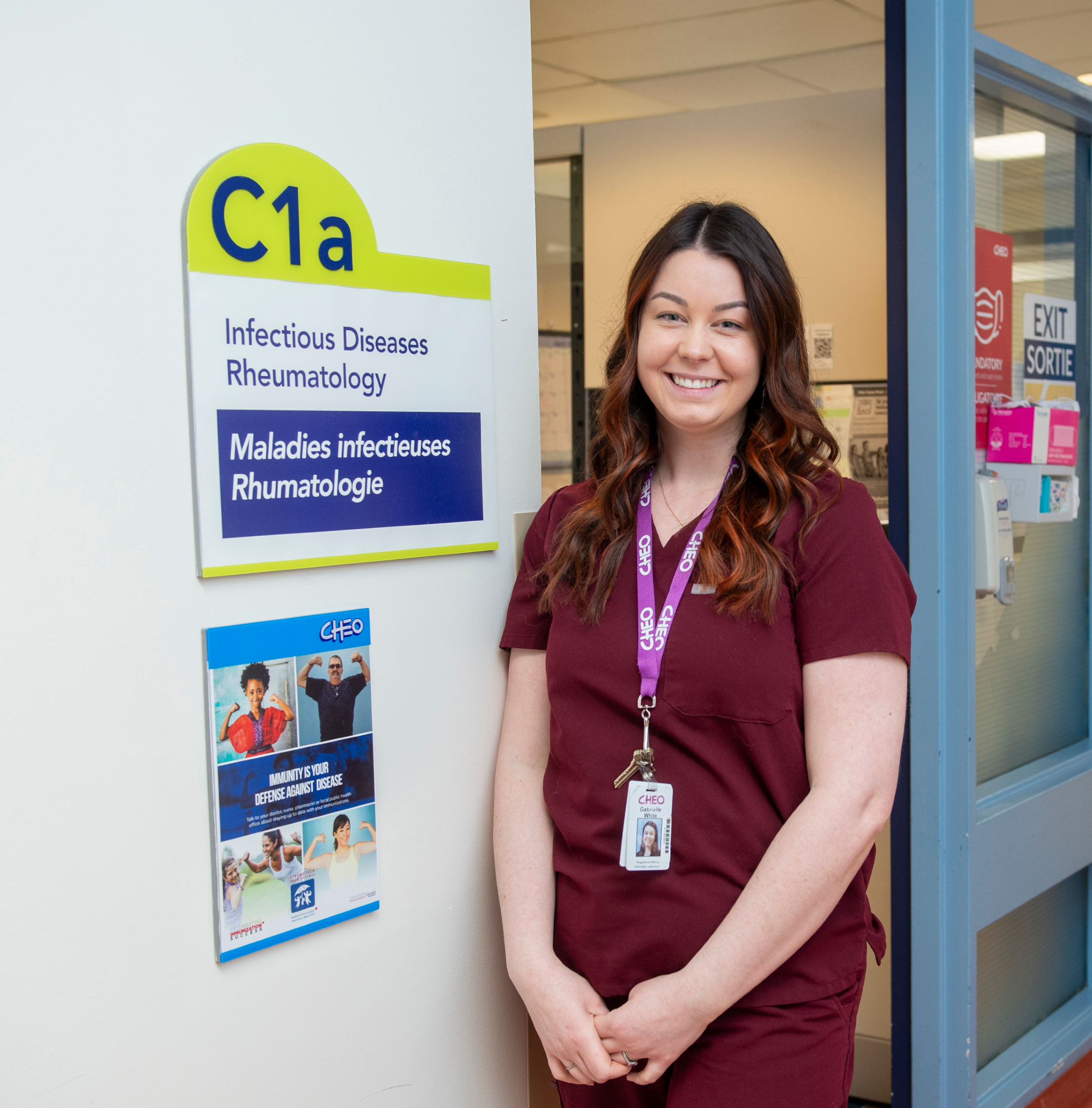 nurse poses for photo outside immunology clinic