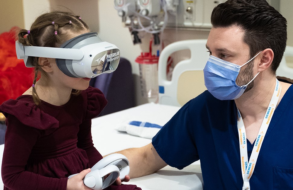 MRI technologist Matt Head with child using virtual reality before MRI