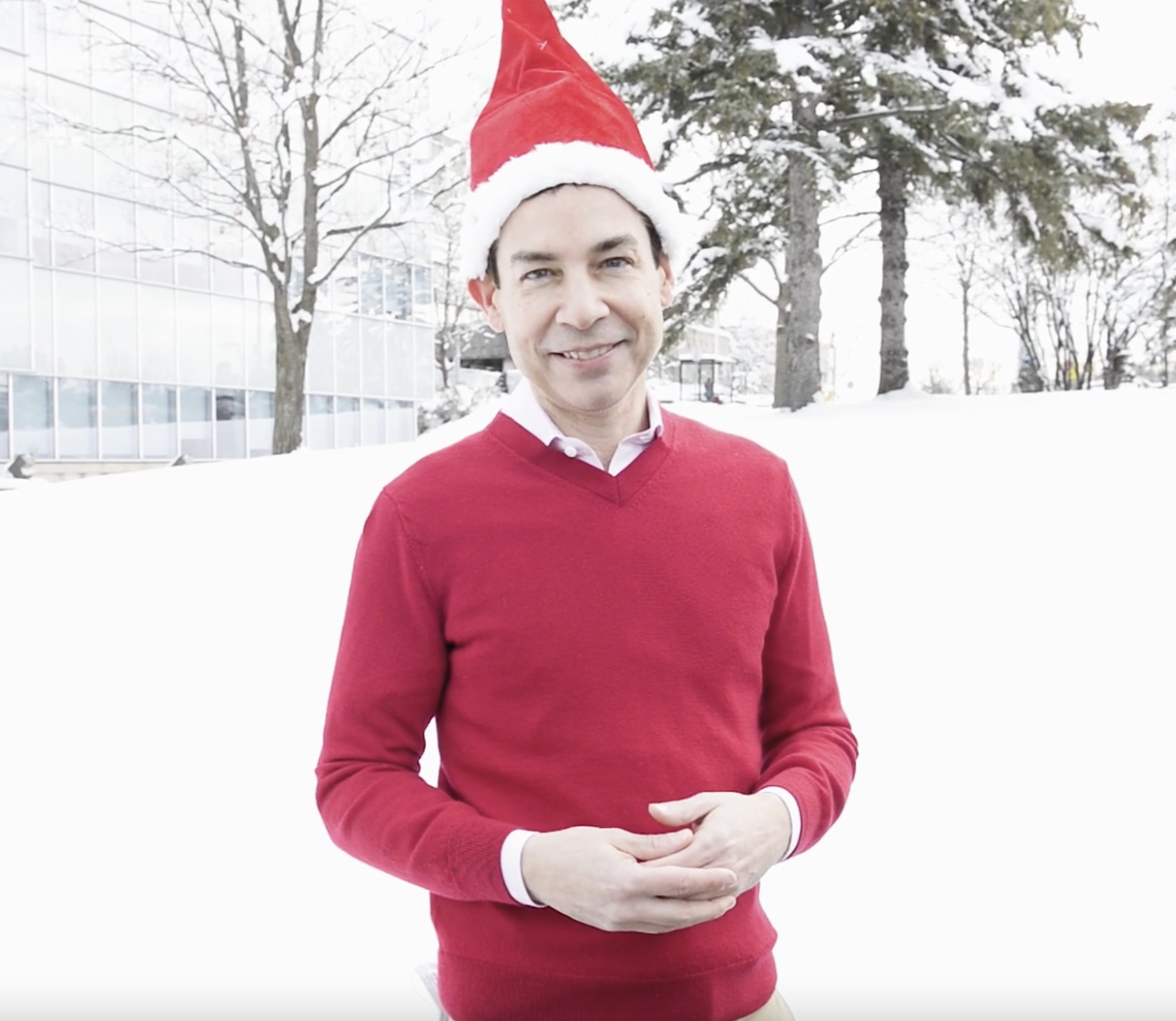 Alex Munter, President and CEO of CHEO, standing outside in a red sweater and santa hat.