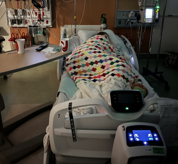 girl lies in pain in CHEO bed