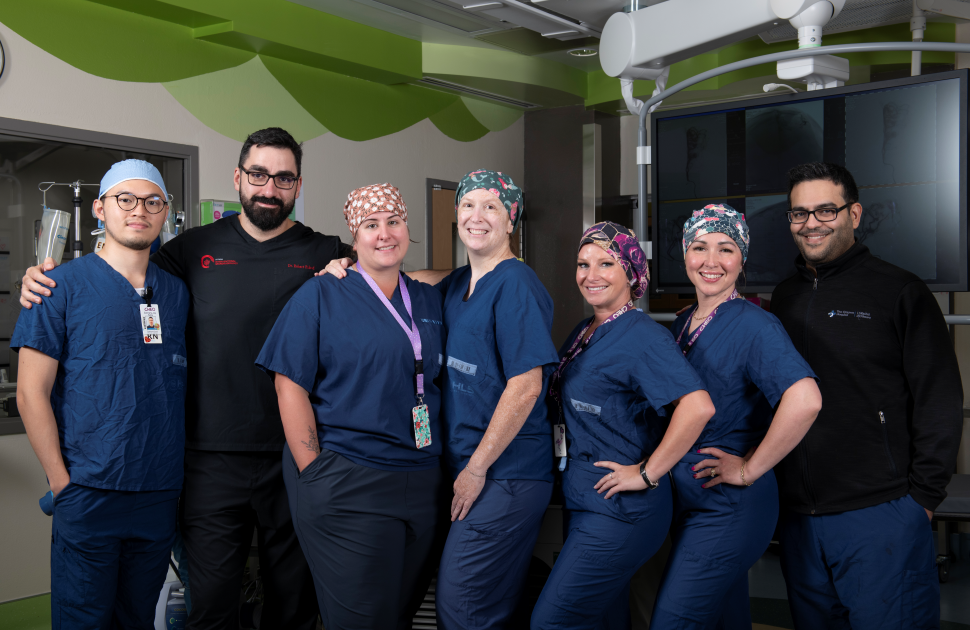 INR team poses for CHEO inside IR Cath Lab
