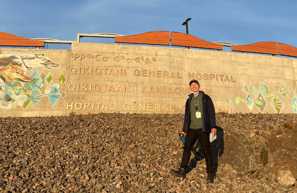 Yipeng, a CHEO resident, standing in front of the Iqaluit hospital