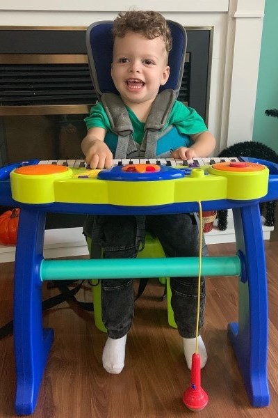 Malakai plays with a toy piano