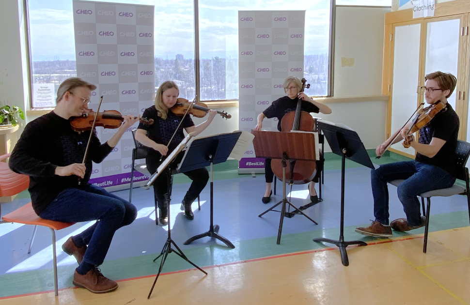 NAC musicians play in cheo hospital hallway in front of window