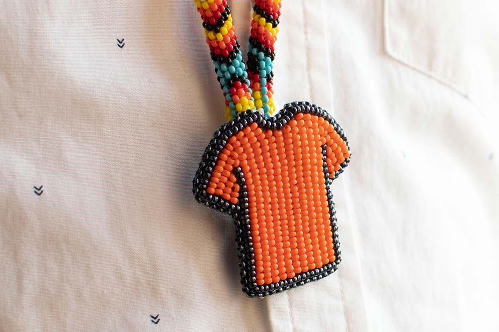A beaded necklace with beads in the shape of an orange shirt.