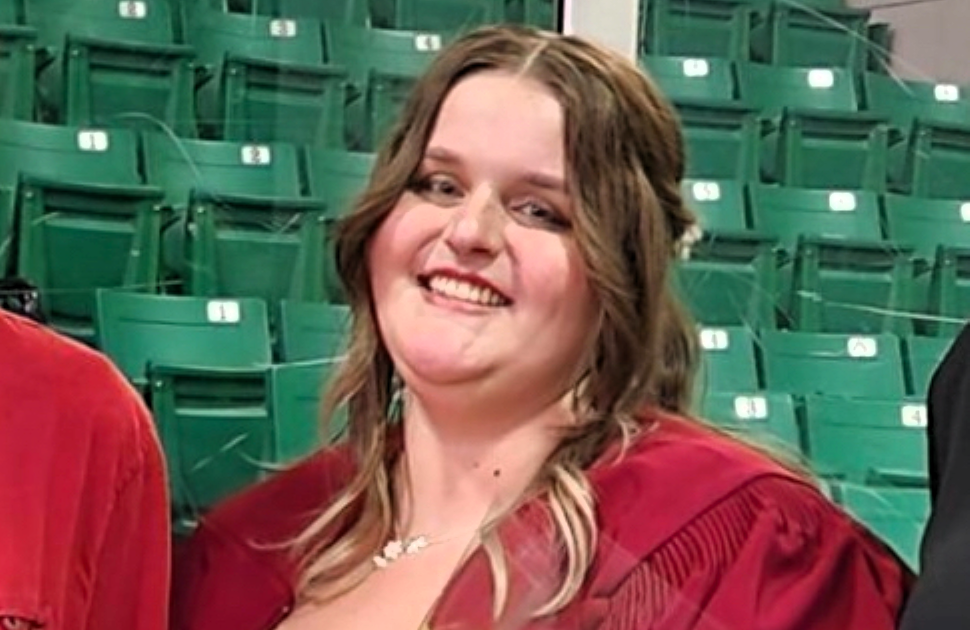 girl smiles looking at camera during high school graduation