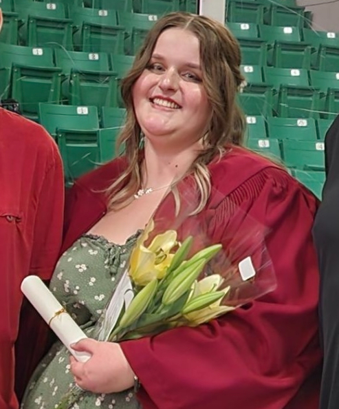 girl smiles looking at camera during high school graduation