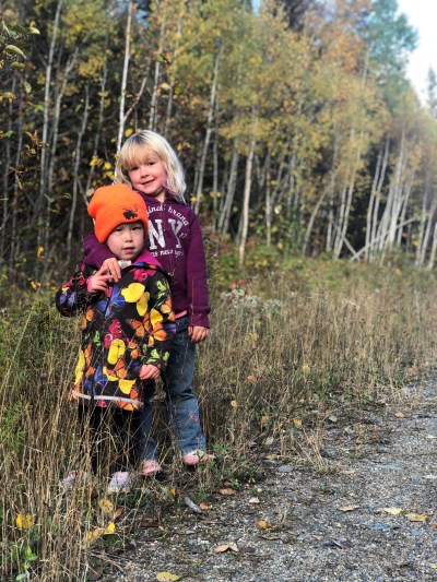 Payton outdoors, smiling at the camera with her family