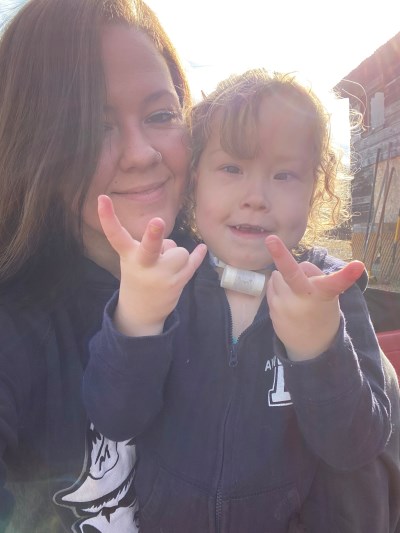 Payton and her mom Taylor smiling at the camera