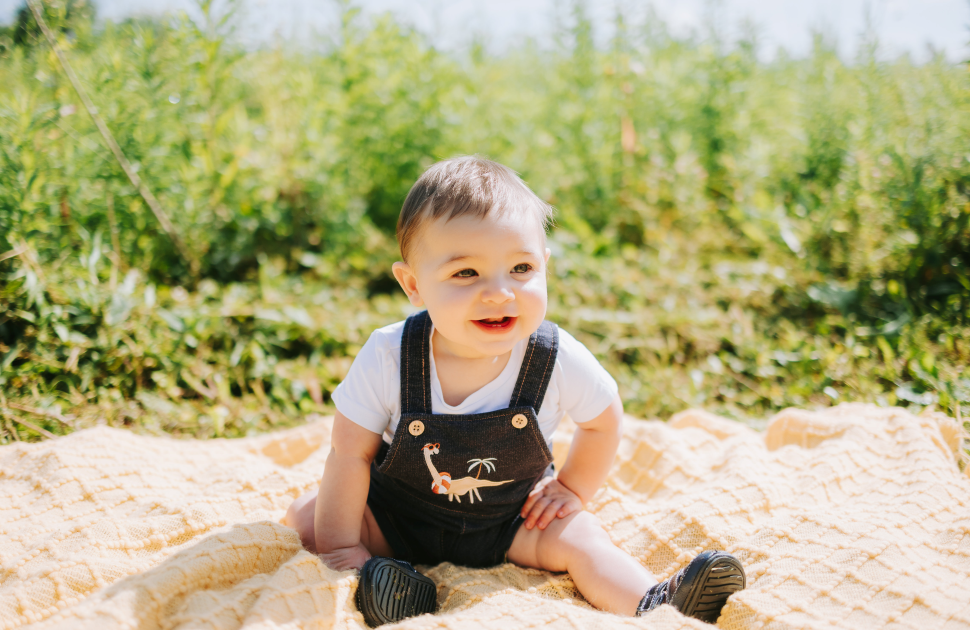 baby smiling sitting on ground