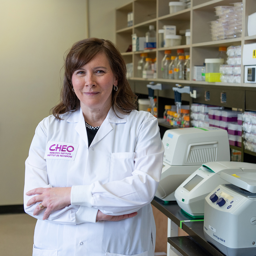 cheo doctor stands in lab with arms crossed