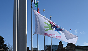 rare disease day flag raised at ottawa city hall with blue sky in background