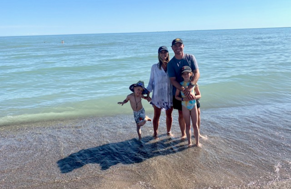 Bell family on the beach posing for camera