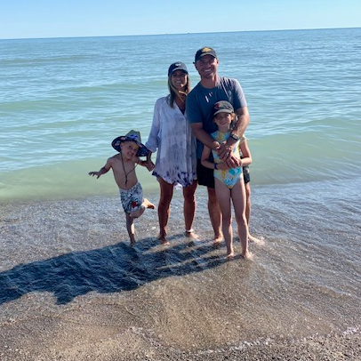 Bell family on the beach posing for camera