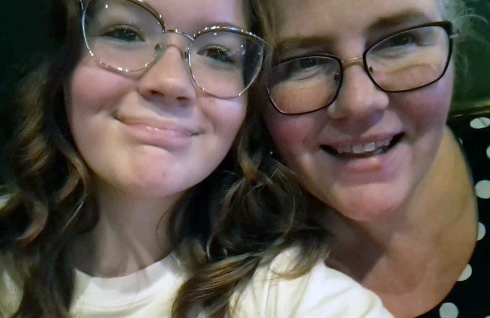 daughter and mother smile in close-up photo