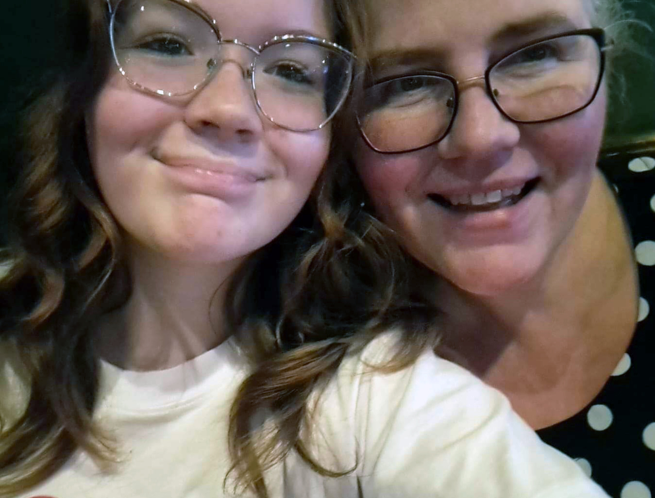 daughter and mother smile in close-up photo