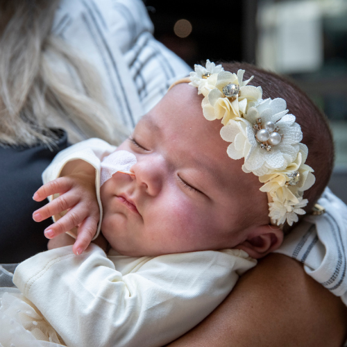 Georgina being held in her mom's arms