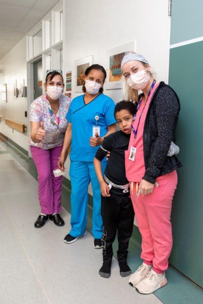 Vitaly and a group of CHEO staff smiling at the camera