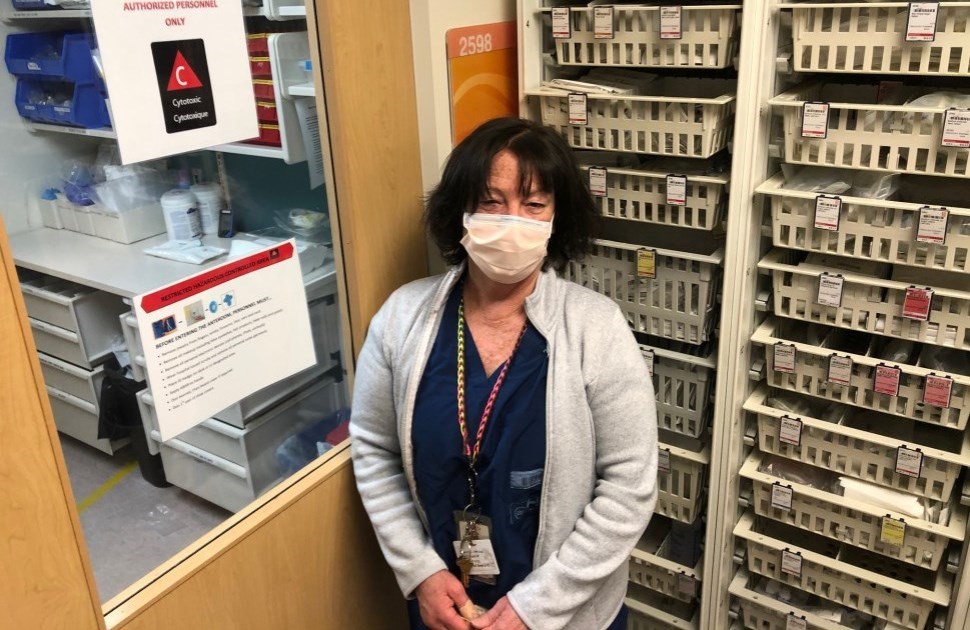 Louise, CHEO pharmacist, standing in front of medication cabinets